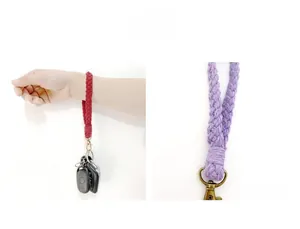 Macro shot of hand-woven cotton wrist strap with vintage bronze clasp and keychain detail