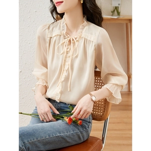 Elegant cream ruffled long sleeve V-neck blouse with lantern sleeves and tied collar detail