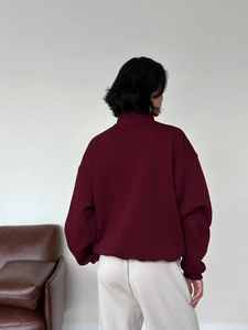Rear view of oversized deep red polo sweatshirt with drop shoulders and tall collar