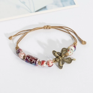Ethnic handmade ceramic bead bracelet with butterfly charm on woven khaki string