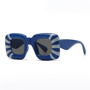 Square frame sunglasses featuring navy blue frames with white radial sunburst patterns