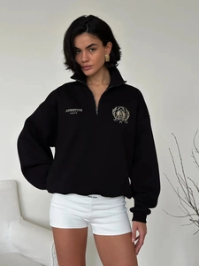 Detail of premium black polo sweatshirt with metal zipper and assertive unity embroidery