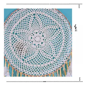 Close-up of handmade off-white crochet dreamcatcher with intricate hollow patterns and feathers