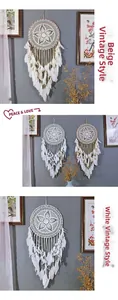 Detail of bohemian dream catcher with white feathers and intricate cotton weave pattern