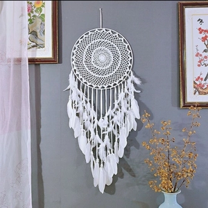 White bohemian dream catcher with soft feathers and beads for wall decoration