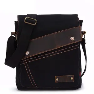 Vintage black canvas messenger bag with brown leather accents and adjustable shoulder strap