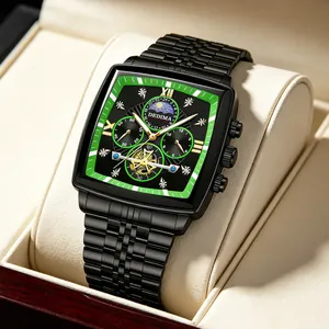 Close-up of black tonneau watch with green dial, moon phase display and gold markers