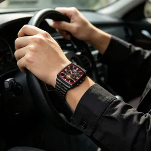 Men's black tonneau watch featuring moon phase and golden roman numerals on the wrist