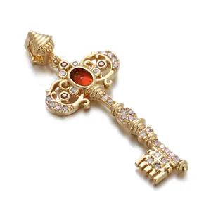 Detailed view of a gold-plated key pendant set with red and white zircons.