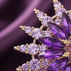 Elegant purple glass snowflake brooch with crystal petals and gold metal finish
