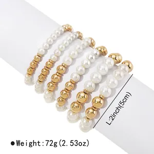 Detail of 6-piece stretch bracelet set with faux pearls and gold beads on white display