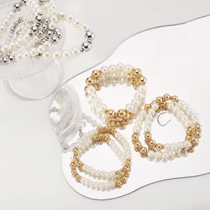 Detailed view of layered faux pearl bracelet set with gold and silver metallic beads