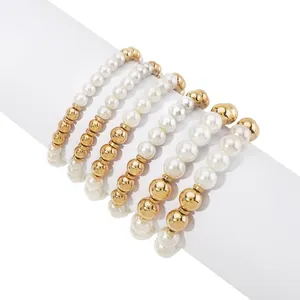 Detail view of 6-piece stacked bracelet set with faux pearls and golden beads on display