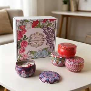 Close-up of four mandala pattern soy candles with dried flower petals in a premium gift box