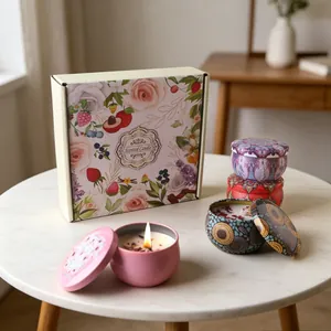 Close-up of scented soy wax candle with dried flowers and colorful floral tin cans