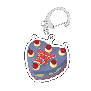 Macro detail of heart-shaped acrylic cake keychain with cherries and Happy Cherry Day text