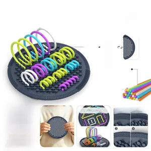 Detail showing sensory activity board with 25 flexible silicone strings for 3D creative play