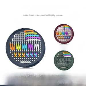 Detail of colorful silicone cords being threaded through the sensory board grid holes