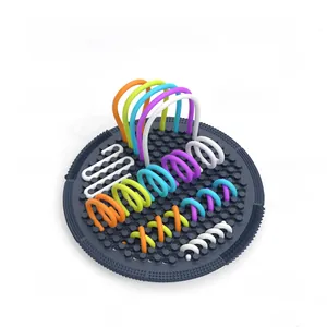 Detail of sensory activity board showing colorful elastic strings for fine motor skills