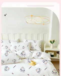 Close-up of portable travel bedding set with blue rabbit print and rabbit lettering