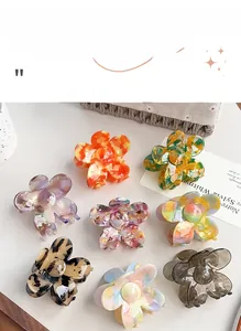 Floral acetate hair claws in various patterns and colors arranged on a white table