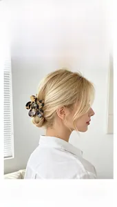 Detail view of acetate flower hair claw clip with brown tortoiseshell pattern texture