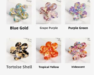 Detail view of acetate flower hair claws in six colors including blue gold and tortoise