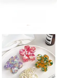 Detailed macro view of acetate flower hair claws in multiple colors and marble texture