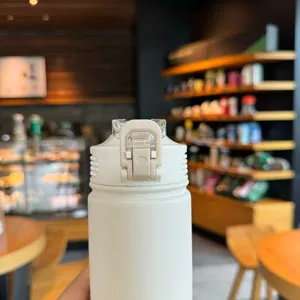 Close-up of matte off-white vacuum flask featuring a secure locking pop-lid mechanism