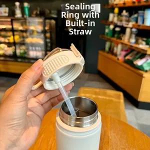 Close-up of white insulated water bottle showing the sealing ring and built-in straw