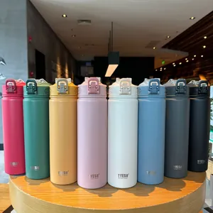 Eight colorful insulated stainless steel bottles with portable handles and matte finish