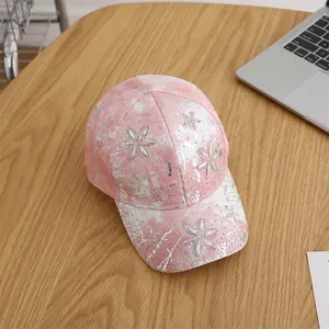 Detailed view of pink tie-dye baseball cap with sparkling rhinestones and floral pattern