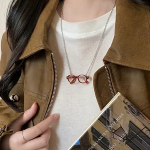 Miniature amber glasses pendant necklace with silver chain for autumn sweater styling