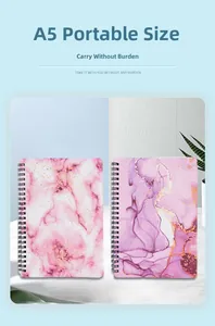 Detailed view of two A5 spiral notebooks with pink and purple marble pattern covers