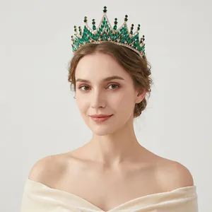 Detail of baroque crown with emerald marquise rhinestones and gold base on model