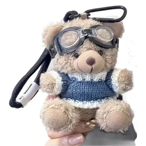 Plush teddy bear keychain with pilot goggles and blue knit sweater for backpacks