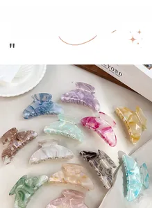 Close-up of assorted marble texture acetate hair claws in various pastel colors