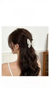 Detail of double-layered butterfly hair claw clip with sparkling glitter finish