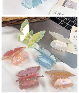 Detailed macro view of acrylic butterfly hair clips with shimmering crystal accents
