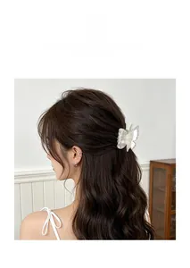 Iridescent white acrylic butterfly hair claw clip shown in a styled hair arrangement