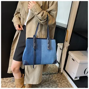 Close-up of contrast denim tote bag with reinforced corners and sturdy blue shoulder straps