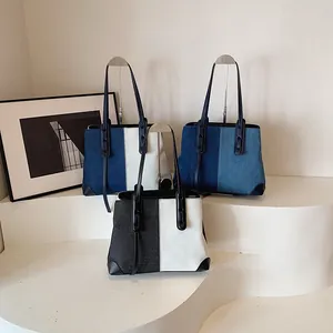 Large denim tote bags for women with contrast leather stitching and long shoulder straps