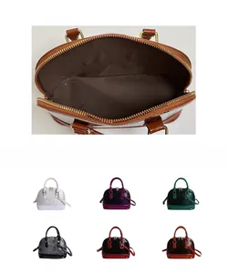 Detail view of shell bag showing internal structure and snake pattern leather in six colors