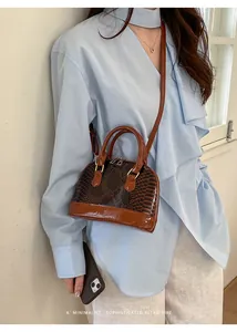 Brown snake print shell bag with glossy finish and minimalist retro vibe