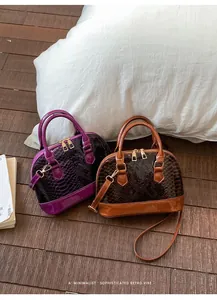 Detail of retro snake pattern shell bags with patent leather trim and gold hardware