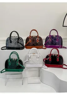 Detail of shell bags in six colors featuring snakeskin texture and glossy patent leather