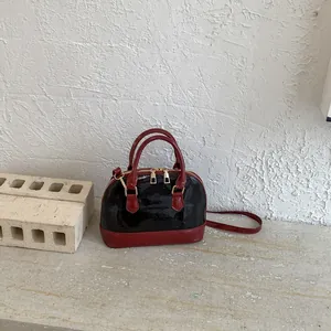 Elegant patent leather shell bag with red handles and black body for women