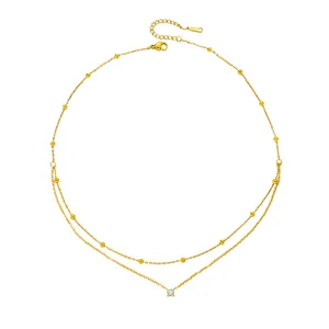 Elegant gold double-layer stainless steel necklace featuring small beads and a single zircon