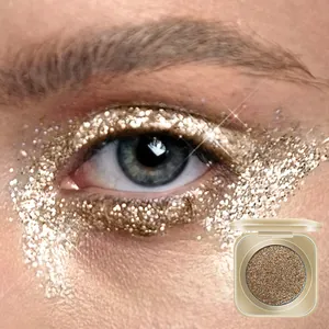 Nahaufnahme von goldglänzendem Glitzerlidschatten auf Auge mit Produkttiegelschau