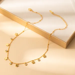 Detailed view of gold petal pendants and zircon charms on a delicate stainless steel chain